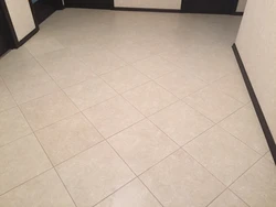 Light tiles in the kitchen and hallway photo