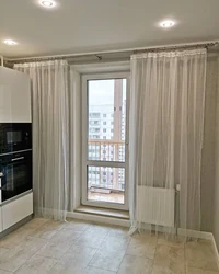 Refrigerator By The Balcony Door In The Kitchen Photo