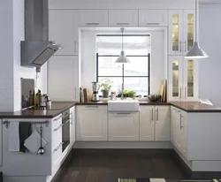 White kitchen with sink by the window photo