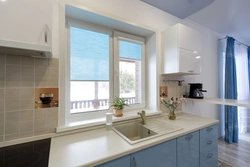 White kitchen with sink by the window photo
