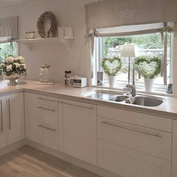 White kitchen with sink by the window photo