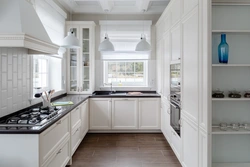 White kitchen with sink by the window photo