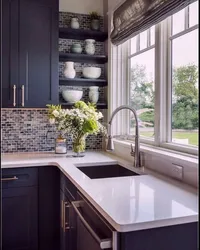 White kitchen with sink by the window photo