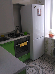 Gas pipe behind the refrigerator in the kitchen photo