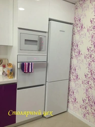 Kitchen refrigerator and oven next to each other photo