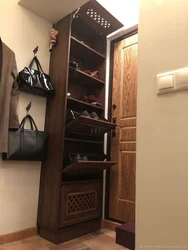 Photo of hallway cabinets with shoe rack and seat