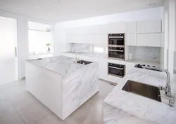 White kitchen with gray marble countertop photo
