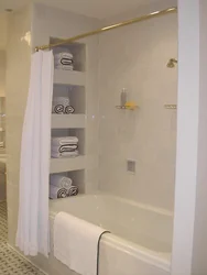 Bathtub with shelves made of tiles or plasterboard photo