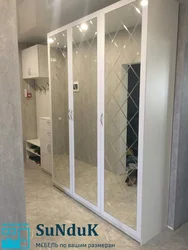 Wardrobe in the hallway white gloss with mirror photo