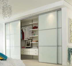 White wardrobe in the bedroom on the entire wall photo