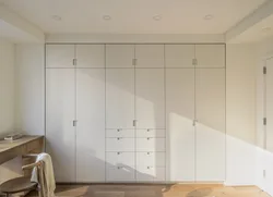 White wardrobe in the bedroom on the entire wall photo