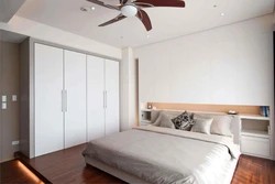 Wardrobe to the ceiling in the bedroom with suspended ceilings photo