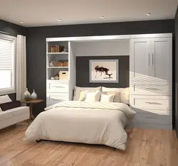 Photo of wardrobes in the bedroom on the entire wall with a bed