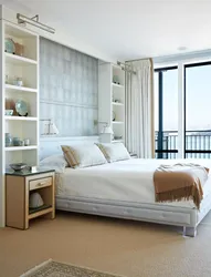 Photo of wardrobes in the bedroom on the entire wall with a bed
