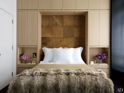 Photo of wardrobes in the bedroom on the entire wall with a bed