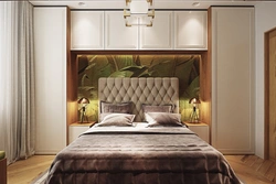 Photo of wardrobes in the bedroom on the entire wall with a bed