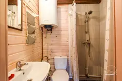 Bathroom in a country house in a wooden house photo with shower