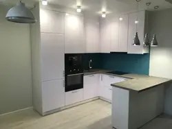 White kitchen with black countertop and bar counter photo