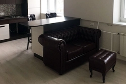 Dark sofa in the kitchen interior