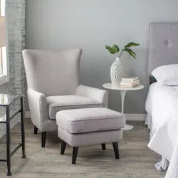 Gray armchair in the bedroom interior