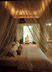Bedroom interior with bed behind curtains