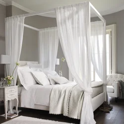 Bedroom interior with bed behind curtains