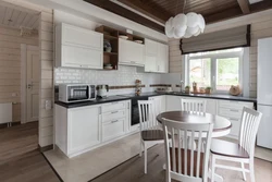 White kitchen in the interior of a wooden house