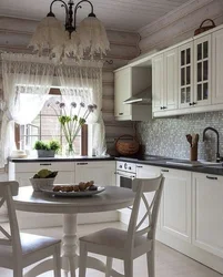 White kitchen in the interior of a wooden house