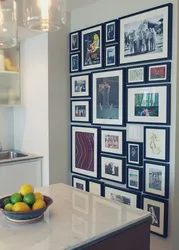 Wall with frames in the kitchen interior