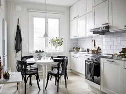 Dark table in the interior of a light kitchen
