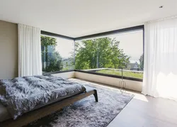 Bedroom interior with floor-to-ceiling windows