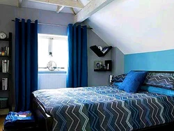 Curtains in the interior of a bedroom with a blue bed