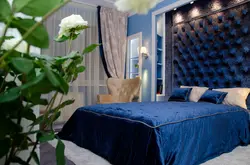 Curtains in the interior of a bedroom with a blue bed