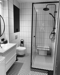 Black shower cabin in the interior of a white bath