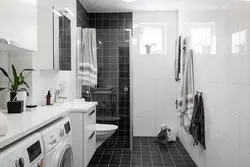 Black shower cabin in the interior of a white bath