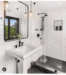 Black shower cabin in the interior of a white bath