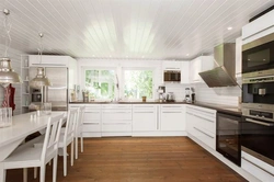 White kitchen interior in a timber house