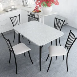 White table with black legs in the kitchen interior