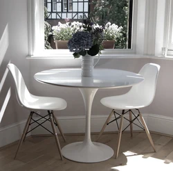 White table with black legs in the kitchen interior