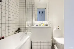White tiles in the bathroom with black grout photo in the interior