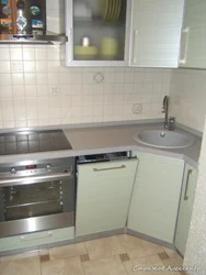 Kitchen in Khrushchev with dishwasher and refrigerator photo