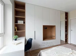 Wardrobe wall with TV in the bedroom photo