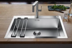 Kitchen sinks built into a stainless steel countertop photo