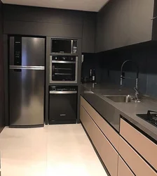 Kitchen design with built-in appliances and refrigerator photo