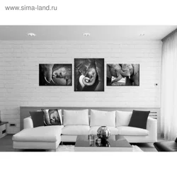 Divan fotosurati ustidagi yashash xonasining ichki qismidagi plakatlar
