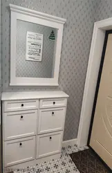 Hallway design with cabinet and mirror