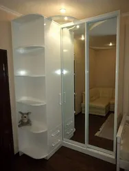 Photo of a corner wardrobe in the bedroom with a mirror