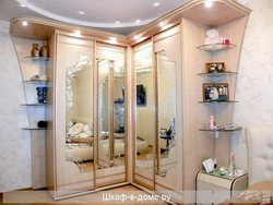 Photo of a corner wardrobe in the bedroom with a mirror