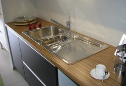Sink On A Wooden Countertop In The Kitchen Photo