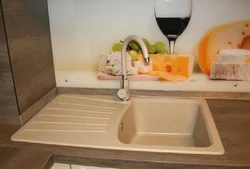 Sink on a wooden countertop in the kitchen photo